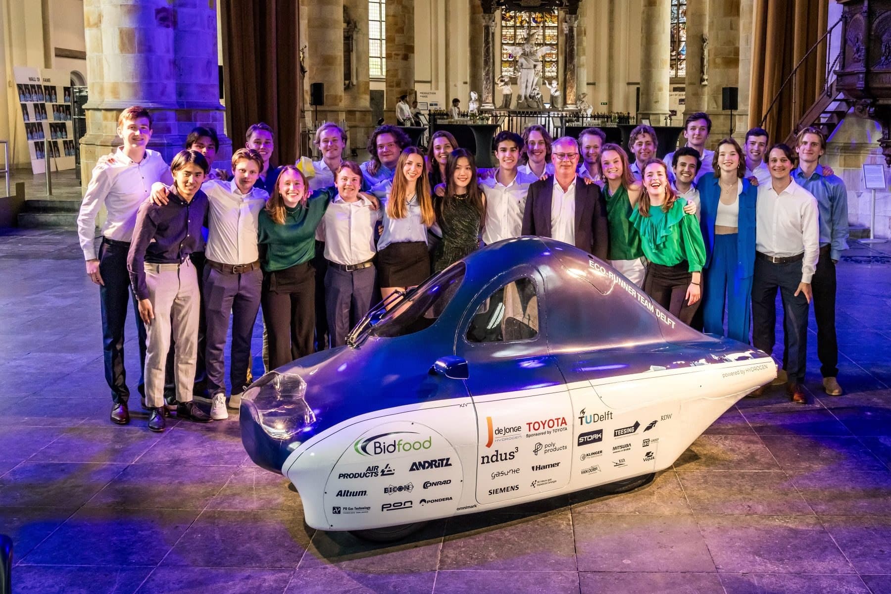 Eco-Runner XIV and the team on stage during the reveal event at the TU Delft Aula