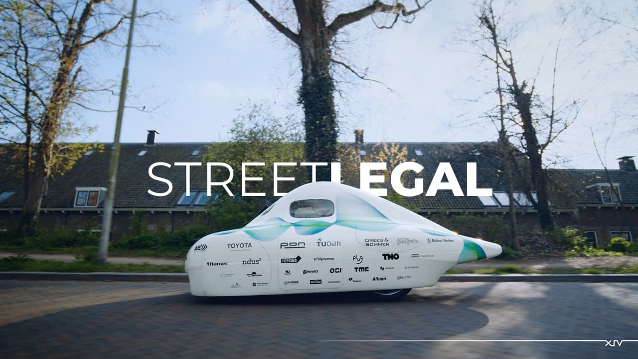 Eco-Runner XIV driving on a public residential street, captioned 'Street Legal'